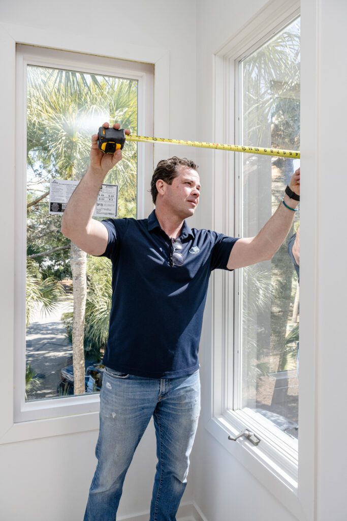 Coastal Shield Window specialist measuring windows for replacement in Charleston SC